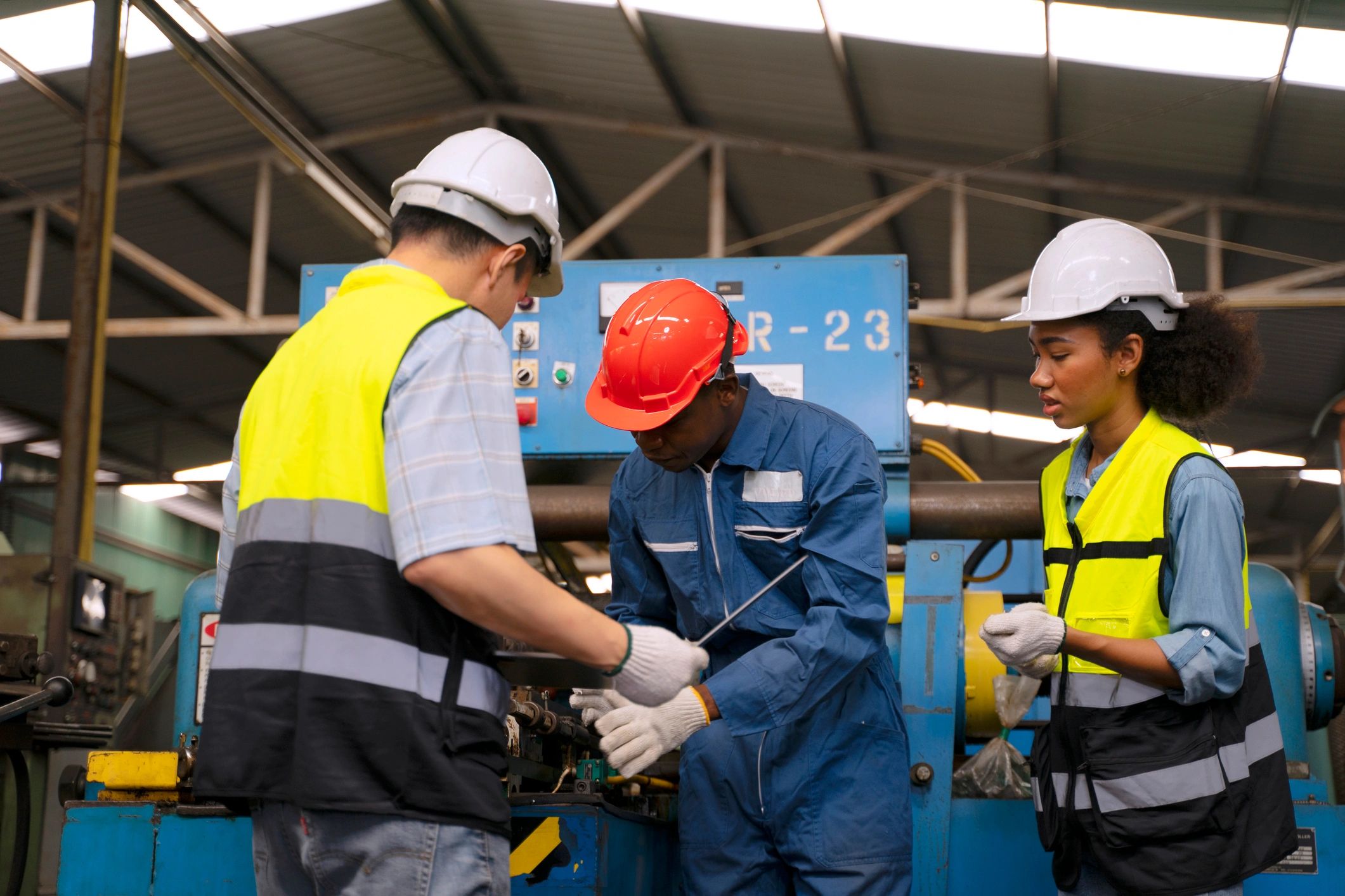 Blue collar workers operating machinery in an industrial training environment
