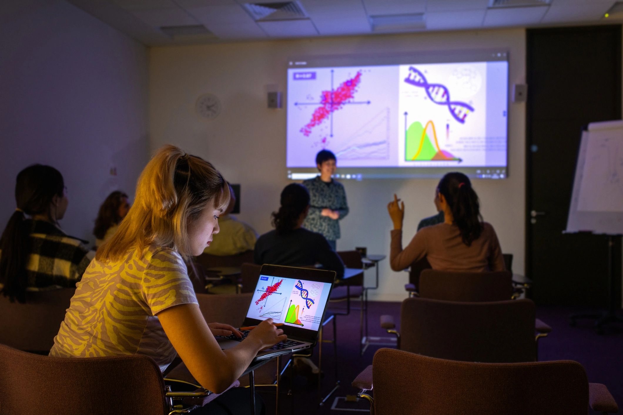Students attending a focused training lecture with laptops