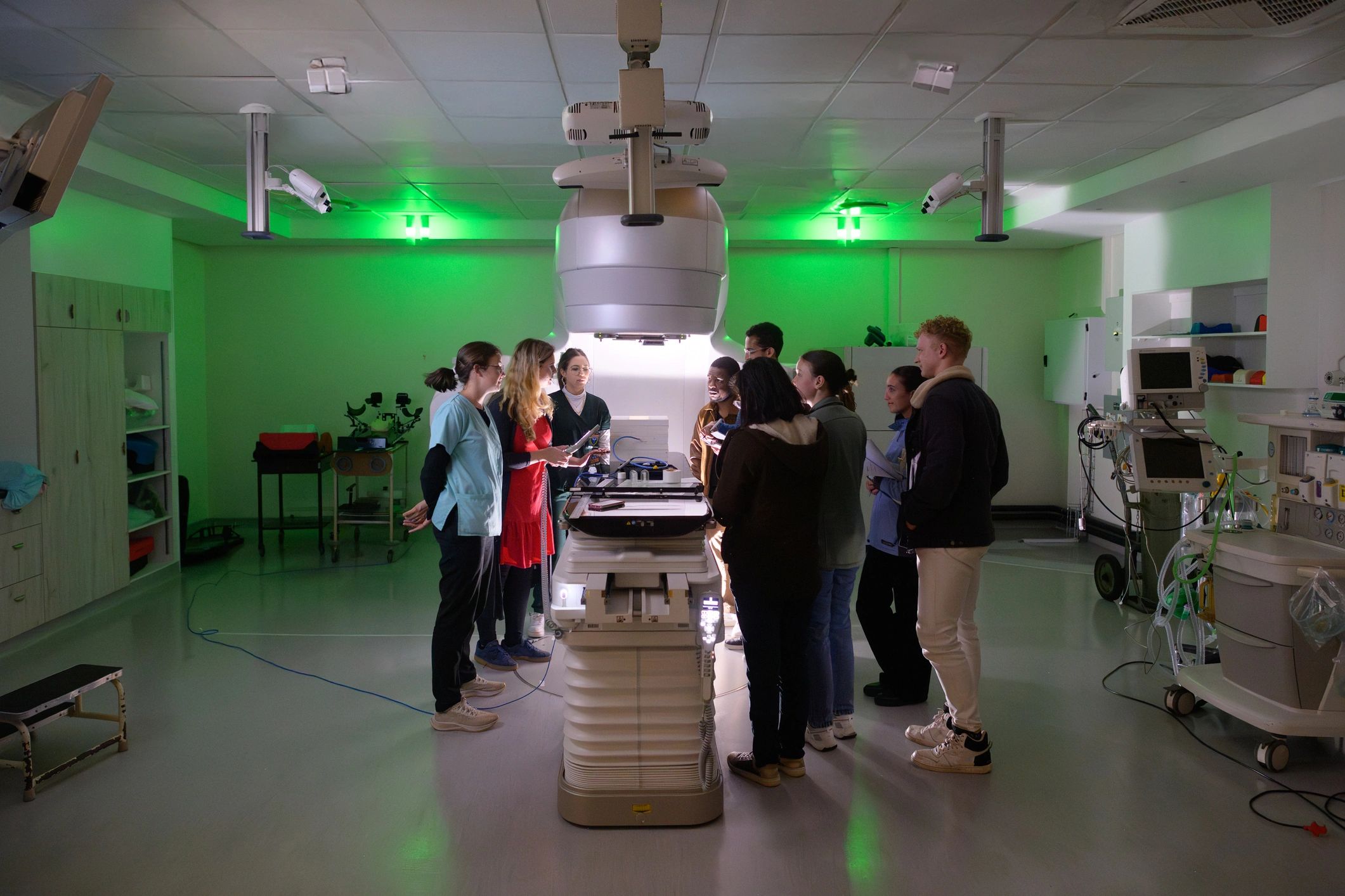 Students studying advanced equipment during a guided training session